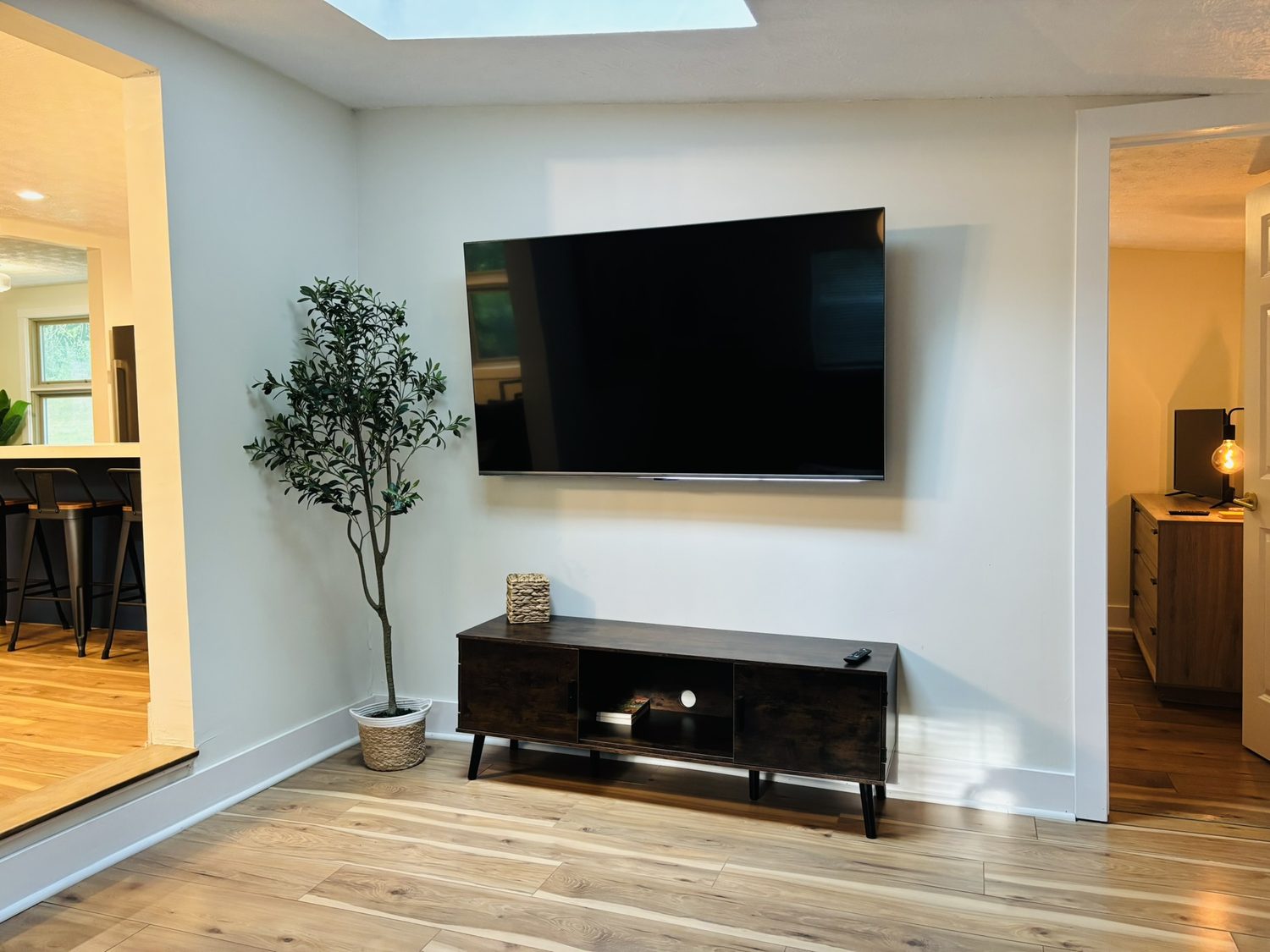 Living area with a wall-mounted smart TV and media console