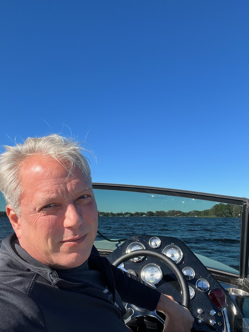 Kurt, owner of Old Beech Cottage, at the helm of his boat on the lake